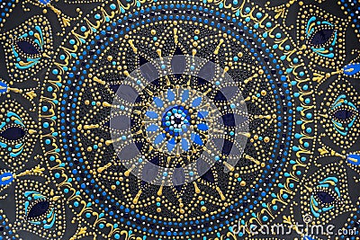Decorative ceramic plate with black, blue and golden colors, painted plate on background , dot painting Stock Photo
