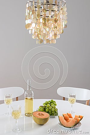 Decorative chandelier and table setting with wine Stock Photo