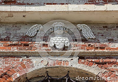 Decorative cherub on the brick wall of an abandoned temple Stock Photo