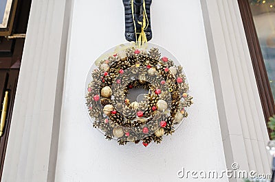 Decorative Christmas decoration on the doors of pine cones and toys Stock Photo