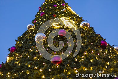 Decorative christmas ornaments baubles on green evergreen branches of a coniferous tree at the christmas markets in Prague Stock Photo