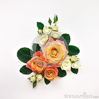 Decorative composition of orange and white roses, green leaves on white background. Flat lay, top view Stock Photo