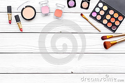 Decorative cosmetics set with eyeshadow, rouge, lipstick, brushes on white desk background top view copy space Stock Photo