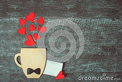 Fathers day concept. Valentines day. Birthday. Decorative Cup with bow-tie and hearts on wooden background. Copyspace. Empty card Stock Photo