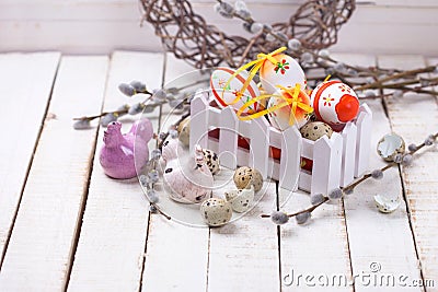 Decorative easter eggs in box, hens and willow branches on w Stock Photo