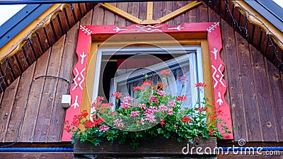 Decorative element of an old wooden house. Red wooden window frame. National symbols of Slovakia Stock Photo