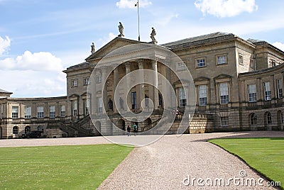 Decorative facade with statues, pediment, columns, and stairways. Stock Photo