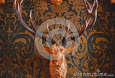 Decorative fake deer head with a patterned background paper. Edited with orange and teal colors Stock Photo