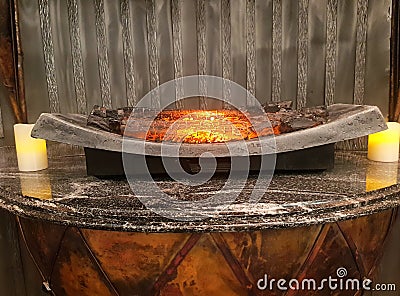 Decorative fireplace with mock-up. Artificial fire on wood Stock Photo