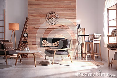 Decorative fireplace with stacked wood in cozy living room Stock Photo