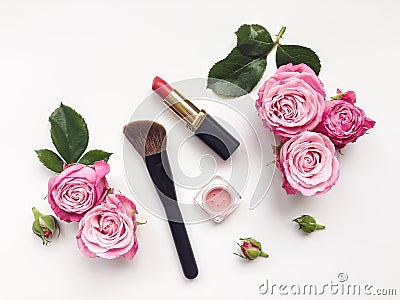 Decorative flat lay composition with cosmetics and flowers. Top view on white background Stock Photo