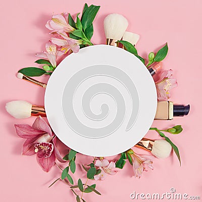 Decorative flat lay composition with makeup products, cosmetics and flowers. Flat lay, top view on pink background Stock Photo