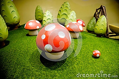 Decorative fly agaric on a green lawn.red mushrooms decoration.many mushrooms, big toys ,ornament.Fairy forest with Stock Photo