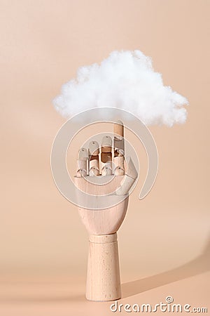 decorative hand made of wood with a cloud on the finger Stock Photo