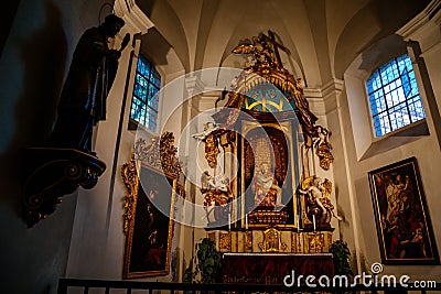 Decorative interior of church St. Henry and St. Kunhuty, Chapel of Virgin Mary, gilded ornamented baroque altar, marble statues, Editorial Stock Photo