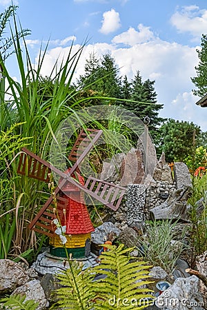 A decorative little windmill in a garden Stock Photo