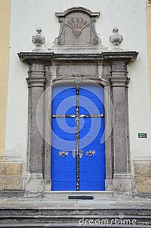 Decorative massive blue side door on late baroque Basilica of Our Lady of Seven Sorrows in Sastin Straze, western Slovakia Stock Photo