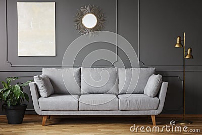 Decorative mirror and modern painting hanging on the wall with m Stock Photo