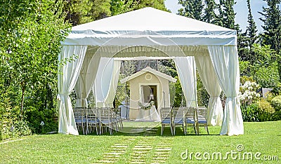 Decorative place for ceremonies or entertainments. Outdoor reception under tents and trees. Stock Photo