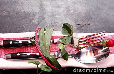 Decorative place setting tied with leaves and rope Stock Photo