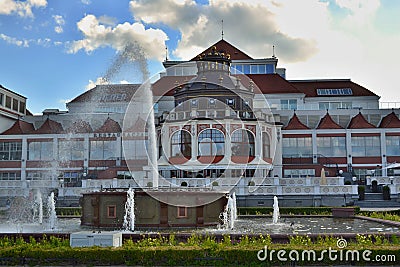 Decorative red and white colored building with fountain and small pool in foreground. Sopot - Baltic region, Poland. Editorial Stock Photo