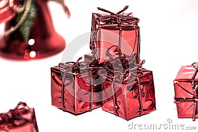 A bunch of gifts wrapped in red shiny paper Stock Photo