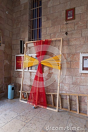 Decorative religious cross woven from ropes in the courtyard of the St. Marys Syriac Orthodox Church in Bethlehem in the Editorial Stock Photo