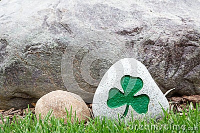 Decorative rock with a painted green shamrock Stock Photo