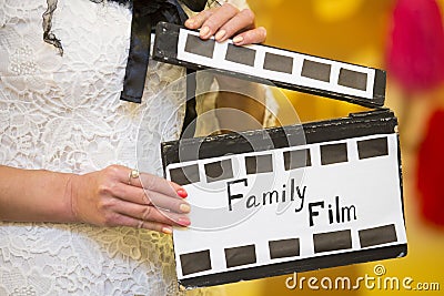 Decorative slapstick cinematic in retro style in hands of woman Stock Photo