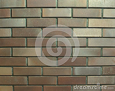 Decorative smooth brick masonry of bronze color with a sand bloom Stock Photo