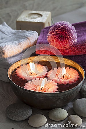 Decorative spa still life with candles, soap, flower and towels Stock Photo