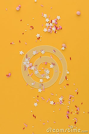 Decorative sprinkles star constellation on yellow background. Stock Photo