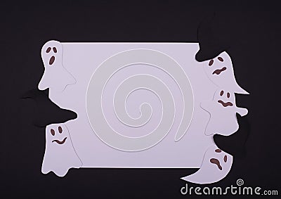 Decorative square white application from flying singing ghosts and spirit, smiling on a black paper background. Flat lay Stock Photo