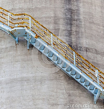 Decorative stairway on exterior of refinery storage tank for pet Stock Photo