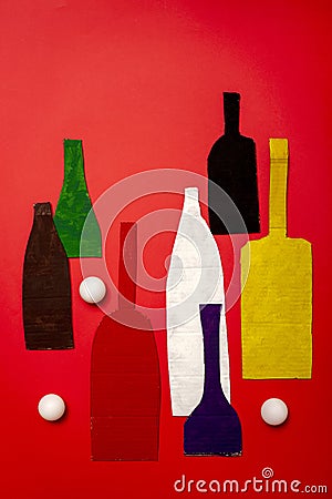 Decorative still life with cardboard cut-out bottles and white balls Stock Photo