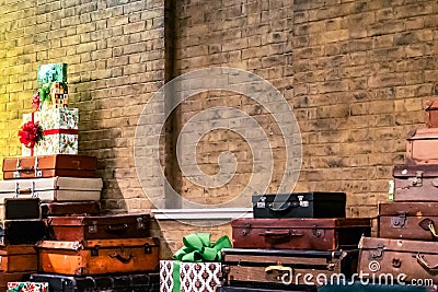 Decorative vintage suitcases and gifts in a brick wall Stock Photo