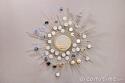 Decorative wall round mirror in the shape of the sun, a golden cooper mirror, modern shape in the Scandinavian style Stock Photo