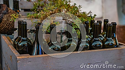 Decorative wine bottles in a grey wooden box Stock Photo
