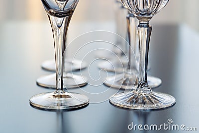 Decorative wine and martini glasses are set up in rows displaying beautiful details of the base of the glass Stock Photo