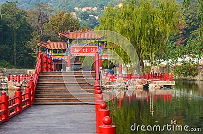 Decorative wooden Chinese gate, architectural arch on the water in Jiangsu Province Editorial Stock Photo