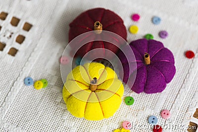 Decorative yelllow, violet and red pumpkins made from felt Stock Photo