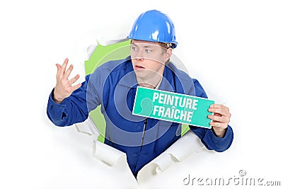 Decorator with a wet paint sign Stock Photo