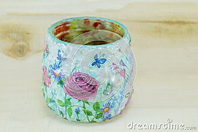 Decoupage decorated flower pattern jar on wooden background Stock Photo