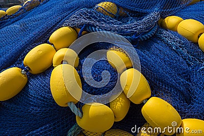 Deep blue fishing net with yellow floats Stock Photo