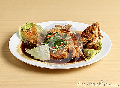 Deep fried grouper served in dish isolated on background top view singapore food Stock Photo