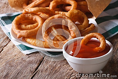 Deep fried onion rings and ketchup closeup. horizontal Stock Photo