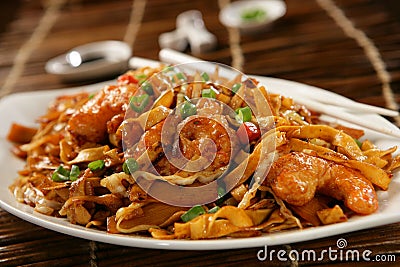 Deep fried scampi with Asian noodles and green pea Stock Photo