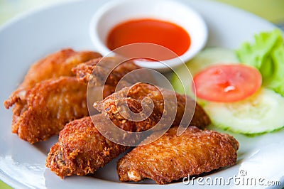 Deep fried spicy chicken wing with sauce Stock Photo