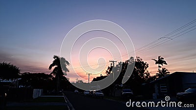 Suburban Sunset with cars, trees, houses and powerlines Stock Photo