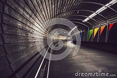 Deep perspective into dark, winding underground tunnel Stock Photo